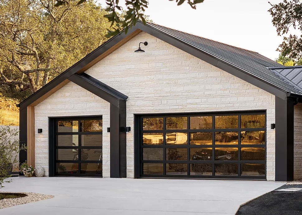 Modern home with full-view glass garage doors installed by Sunshine State Garage Pros